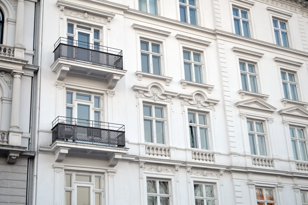 a large white building with balconies and windows