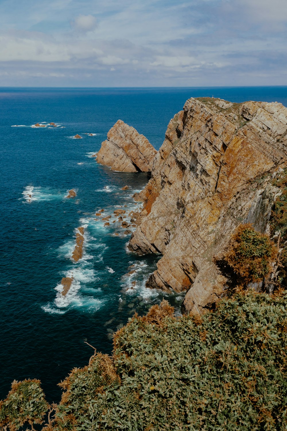 a view of the ocean from the top of a hill