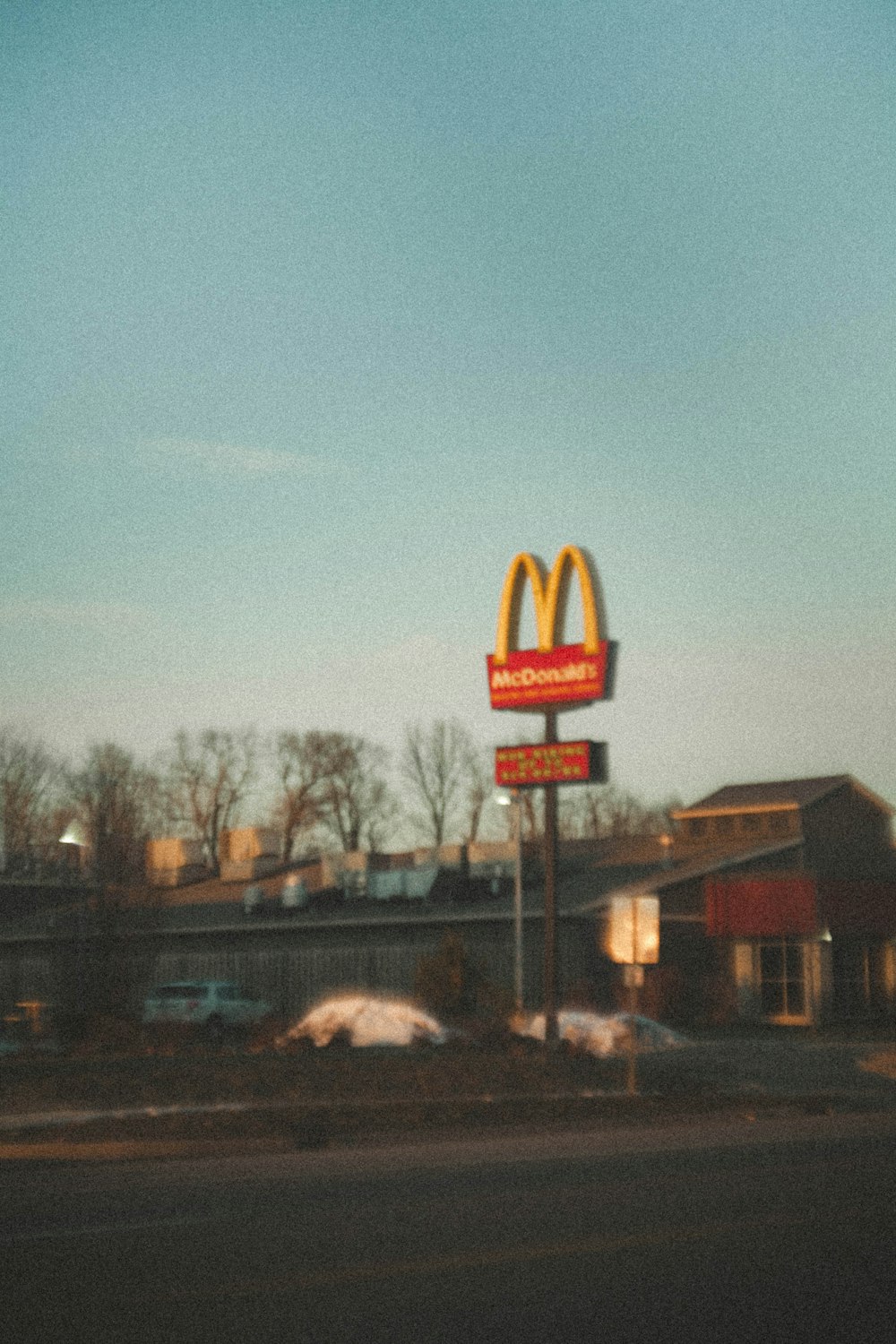 a mcdonald's sign in front of a mcdonald's restaurant