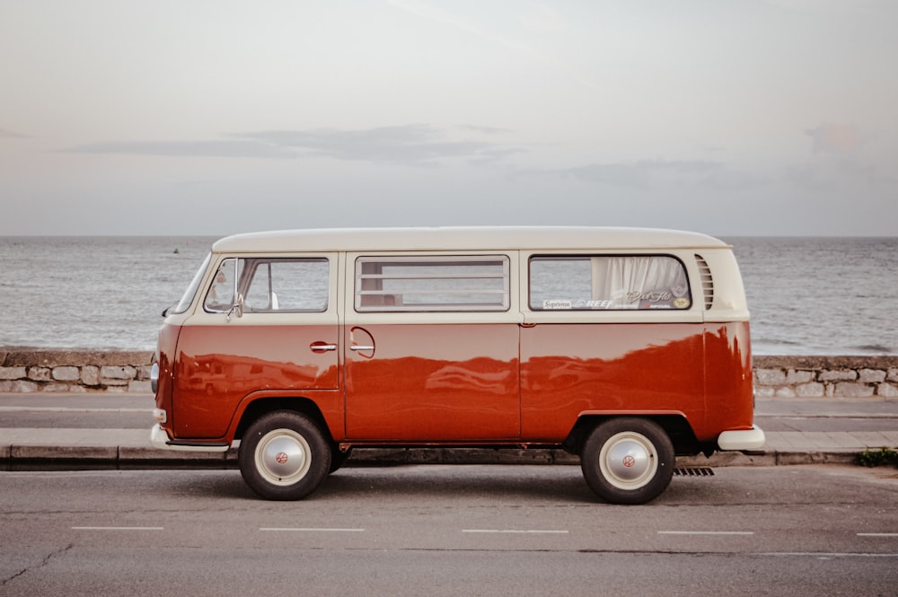 an orange and white van parked on the side of the road