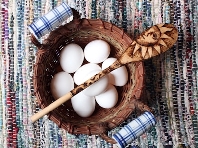 A basket filled with farm-fresh eggs and homemade butter wrapped in cloth