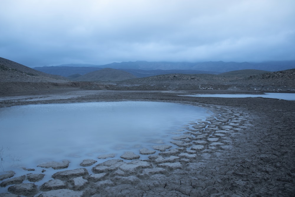 a body of water with a mountain in the background