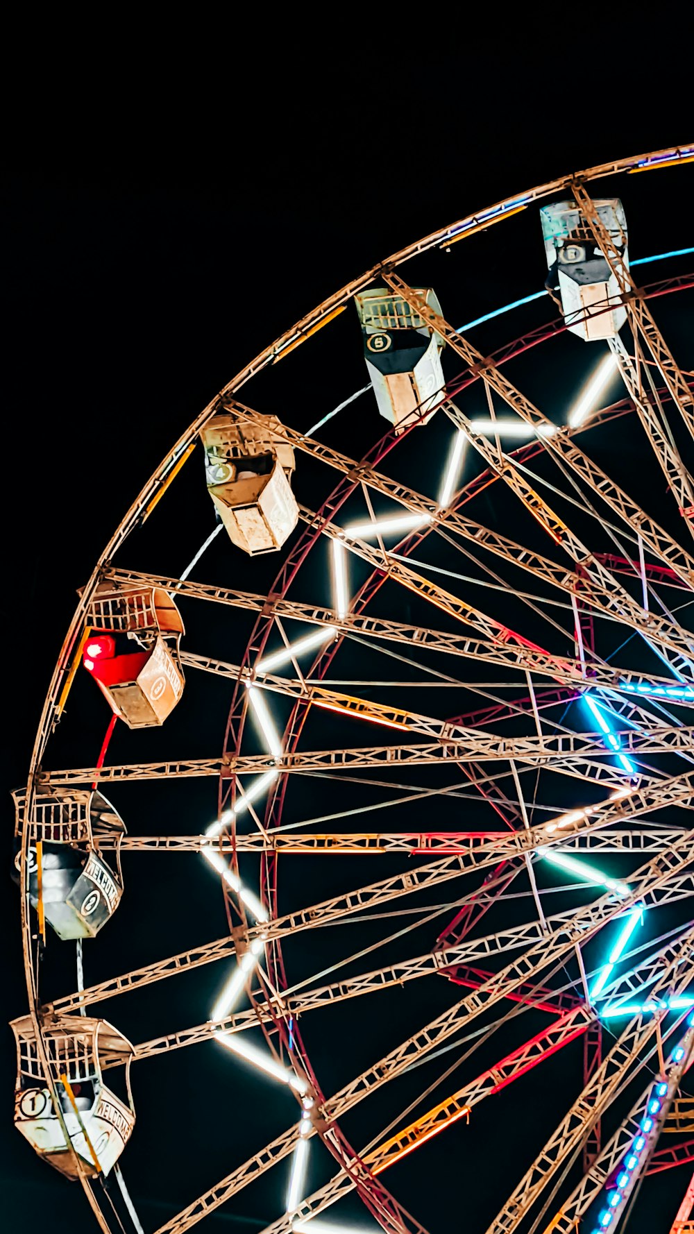 a ferris wheel lit up in the night sky