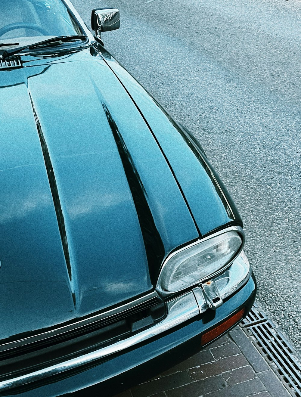 a blue car parked on the side of the road