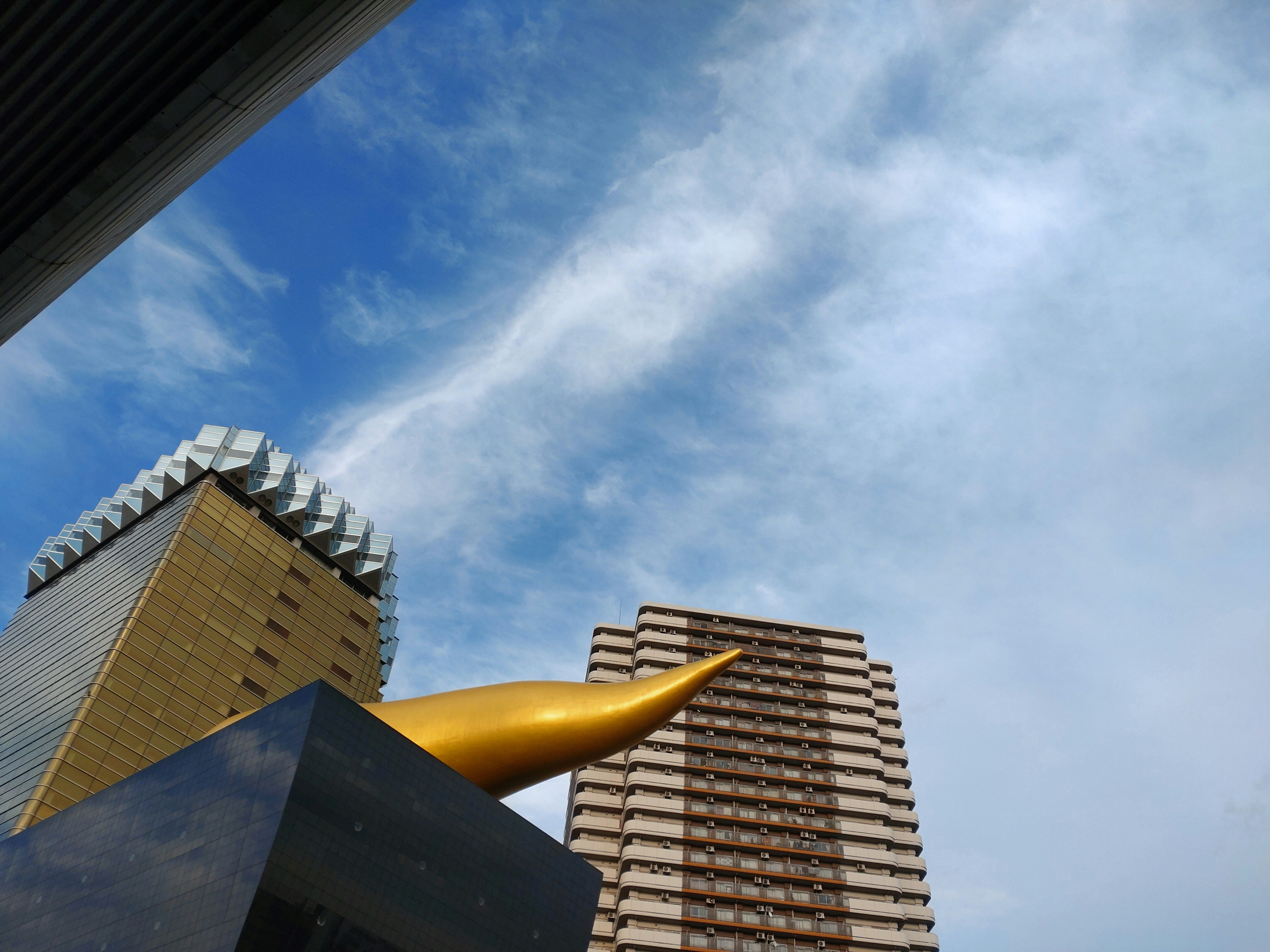 a tall building next to a very tall building