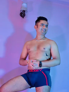 A confident man smiling with a subtle glow, symbolizing improved sexual health.