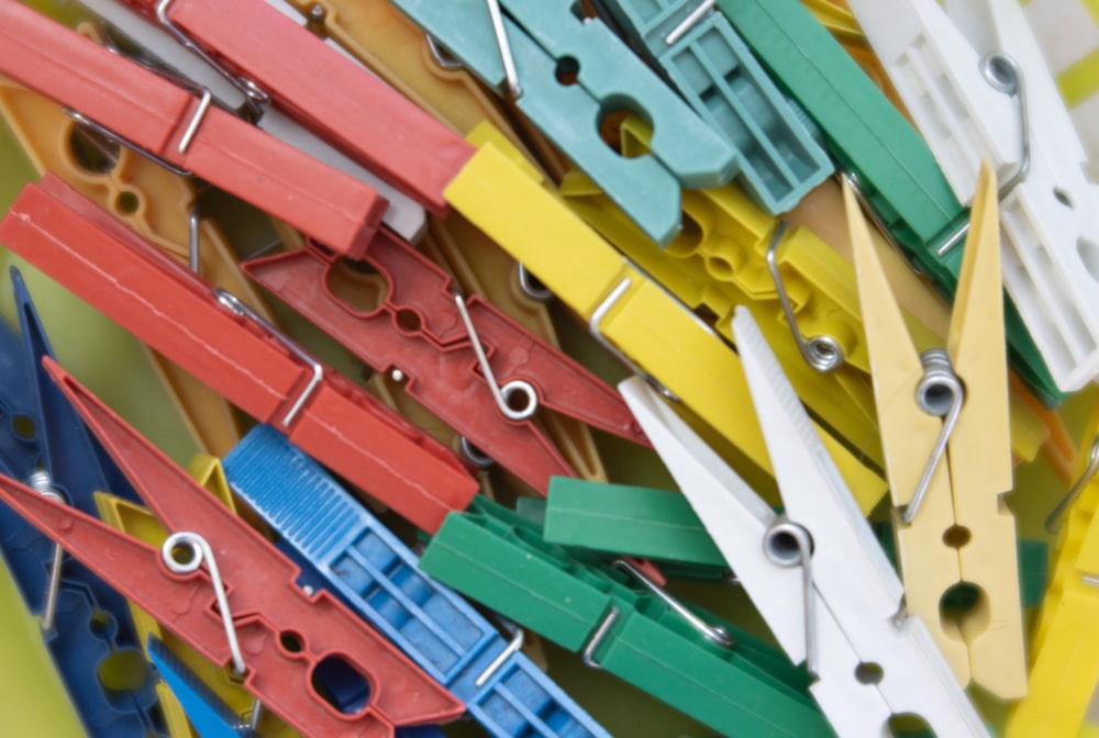 a pile of colorful binders with holes in them