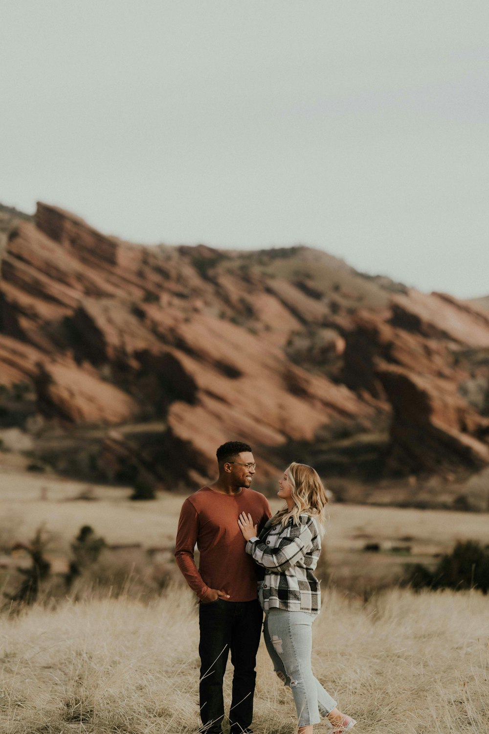 a man and a woman standing in a field