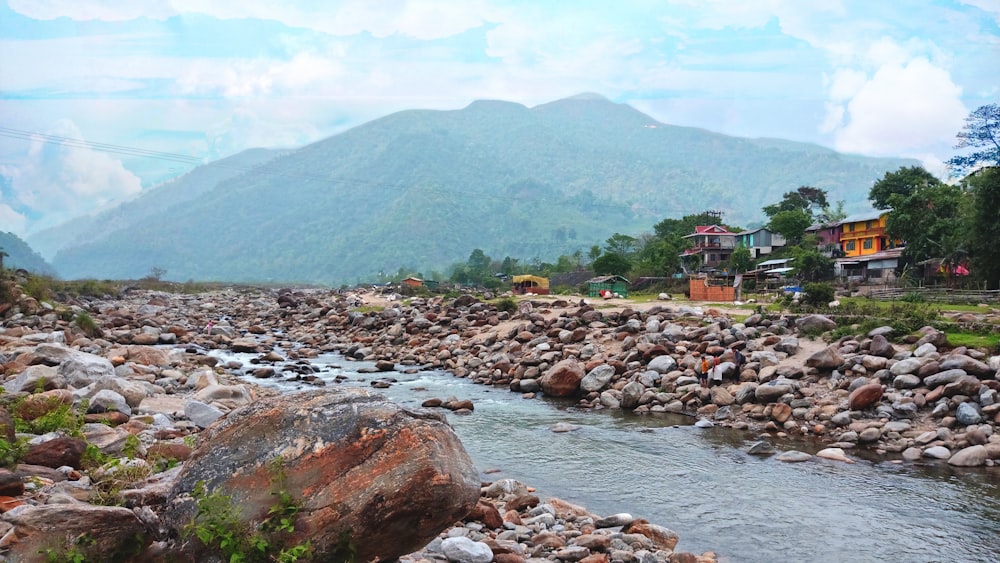 a river running through a lush green hillside