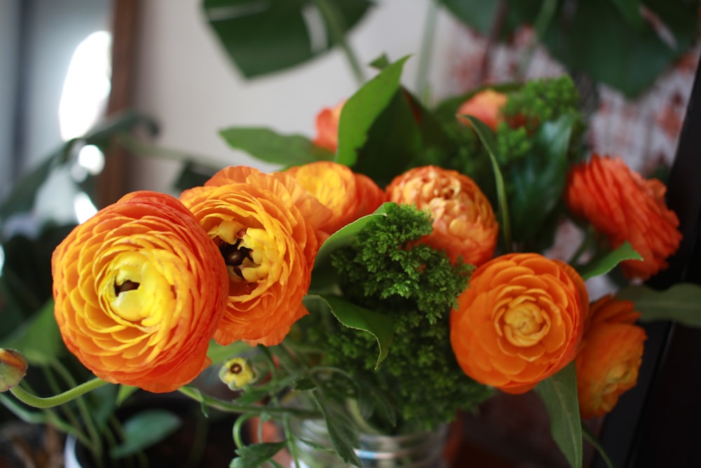 a vase filled with orange and yellow flowers
