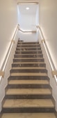 a set of stairs leading up to a skylight