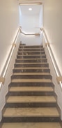 a set of stairs leading up to a skylight