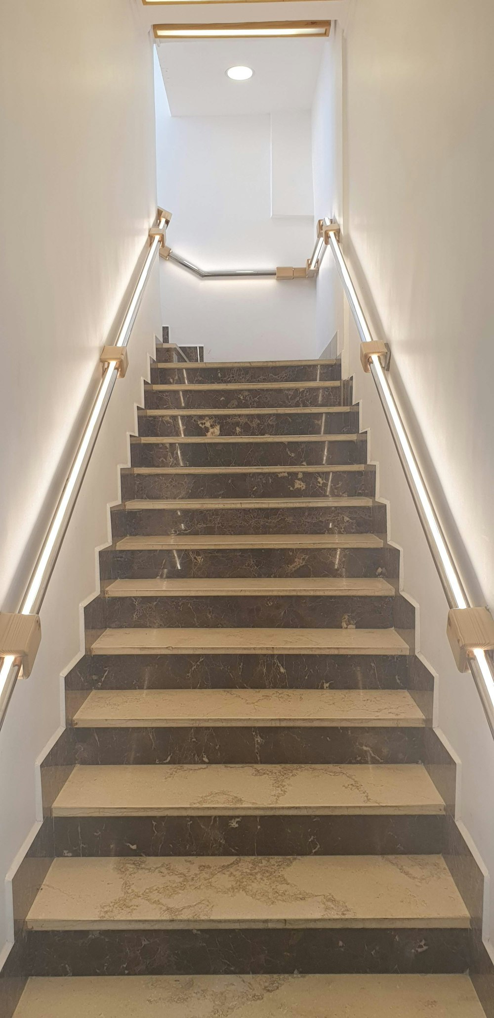 a set of stairs leading up to a skylight