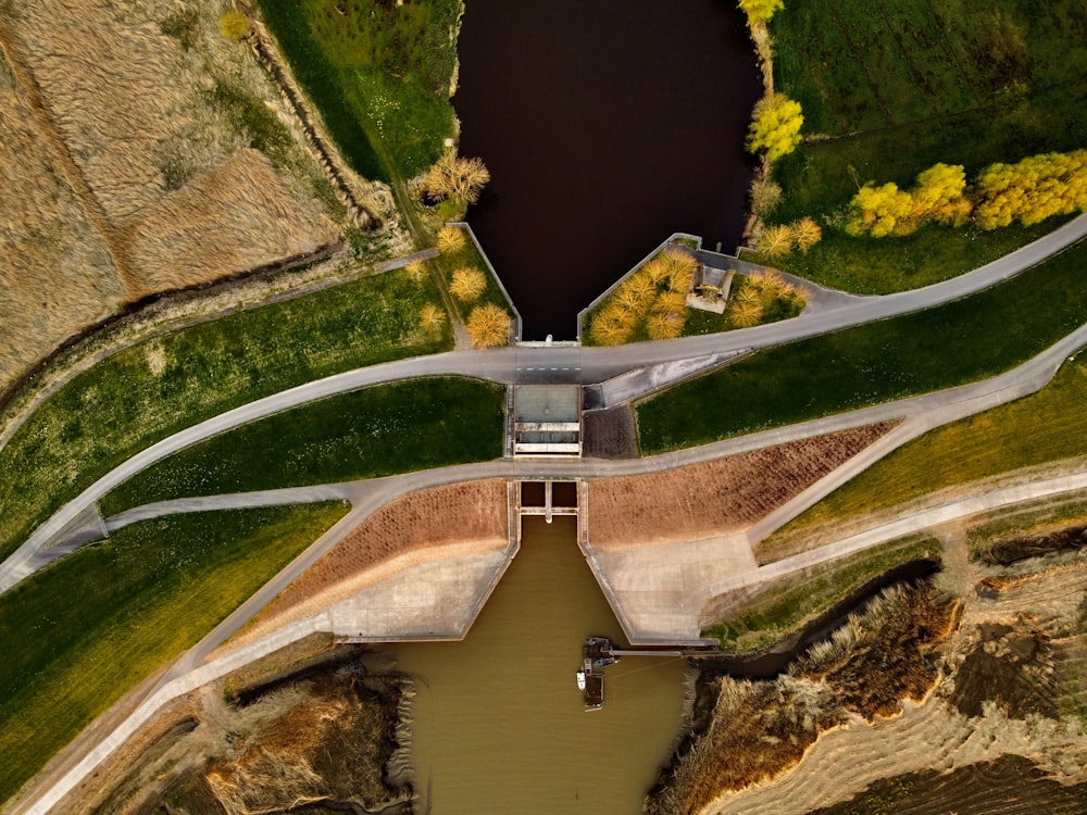 an aerial view of a road and a body of water