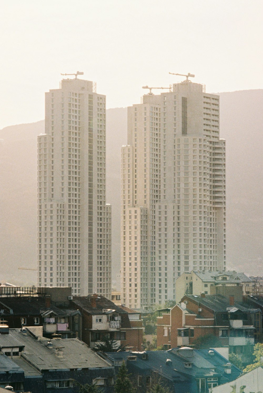 a couple of tall buildings sitting next to each other