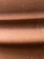 Close-up of the Shishira clay fridge showing its textured surface and natural finish.