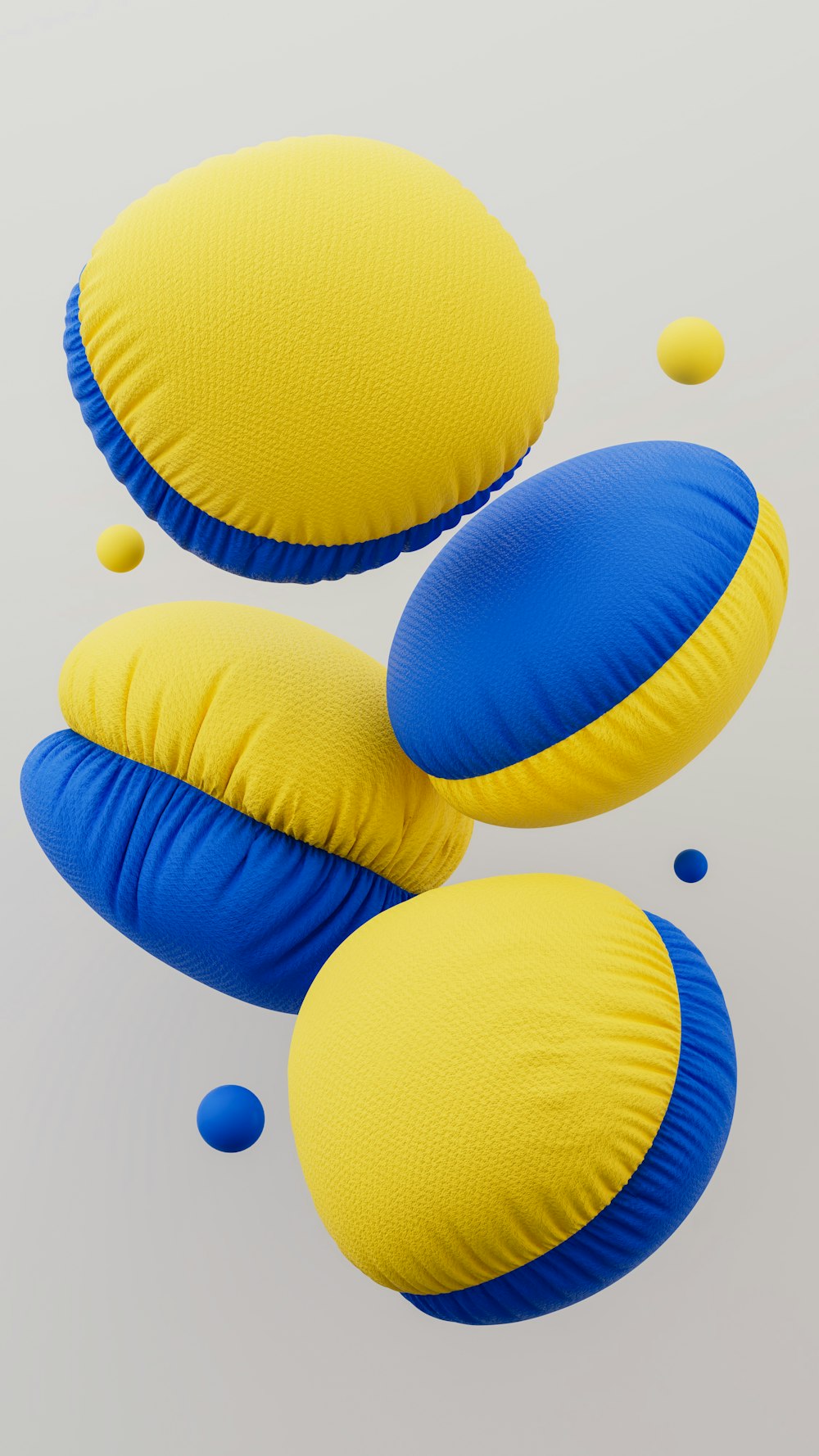 three yellow and blue pillows floating in the air