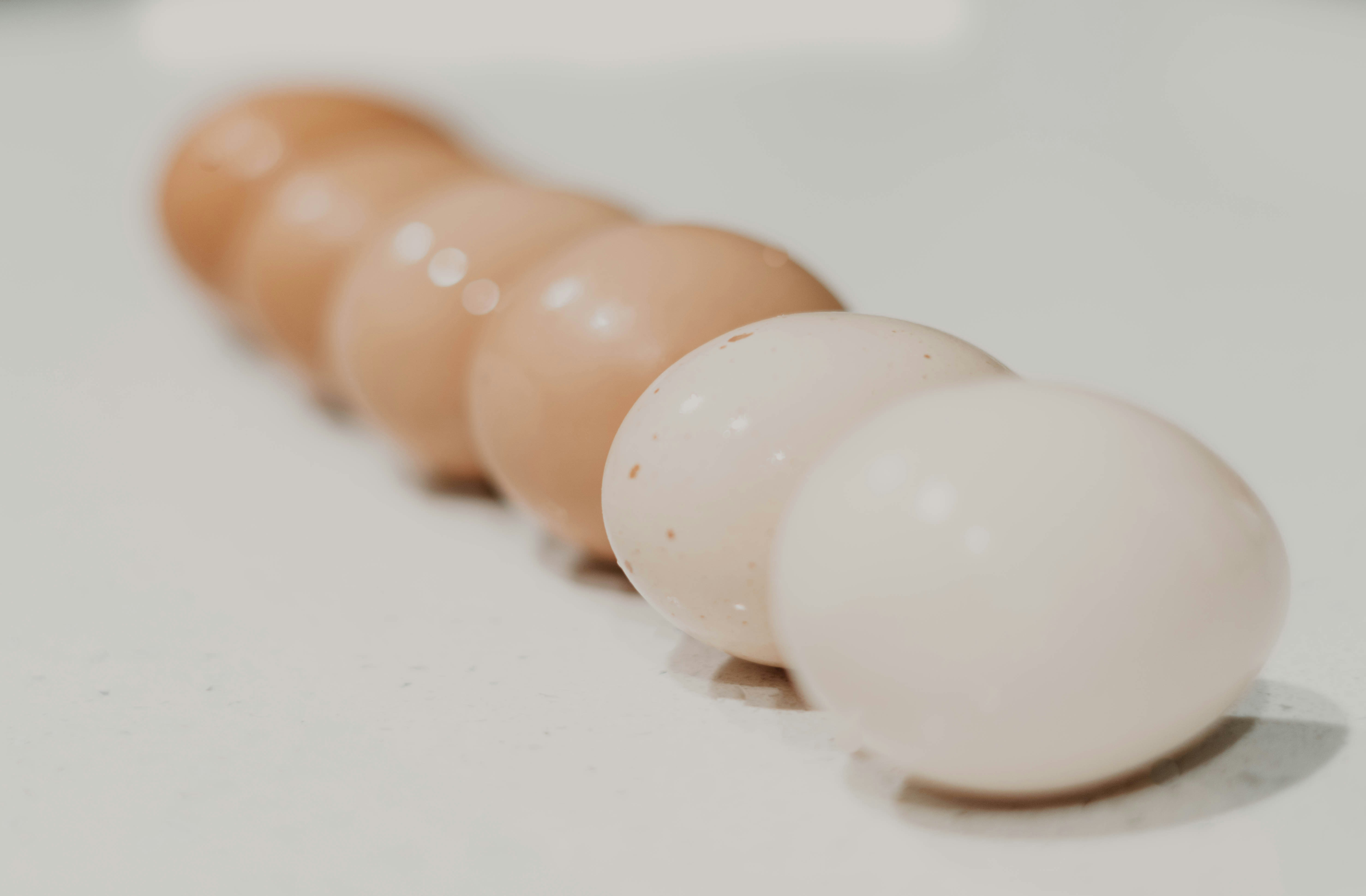 a row of eggs sitting on top of a white counter