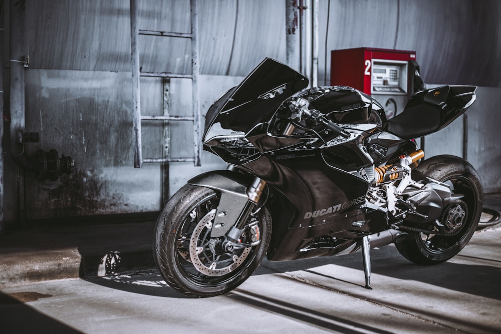 a black motorcycle parked in front of a building