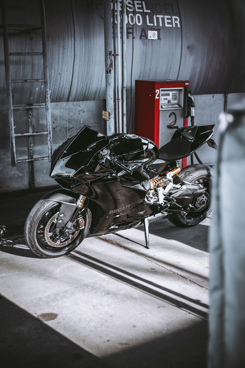 a motorcycle parked in a garage next to a machine