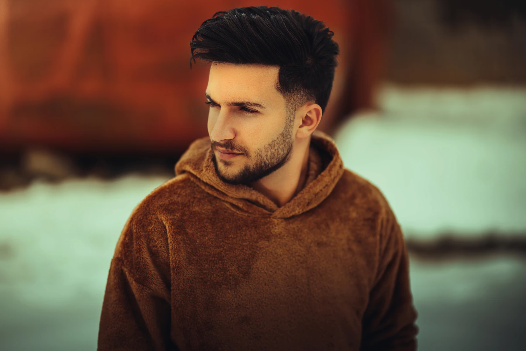 A man with full, dark hair in warm light
