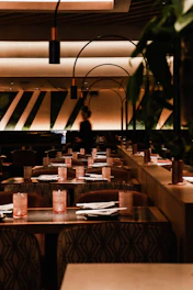 a dimly lit restaurant with tables and chairs