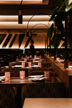 a dimly lit restaurant with tables and chairs