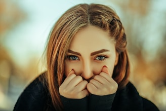 a woman covering her face with her hands