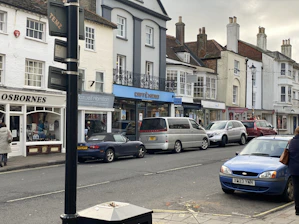 A warm, inviting shot of the Browns of Harborne shopfront on a bustling street in Birmingham.
