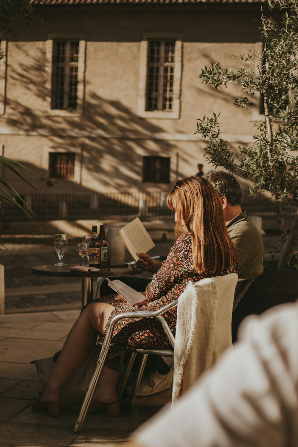 a man and a woman sitting at a table outside