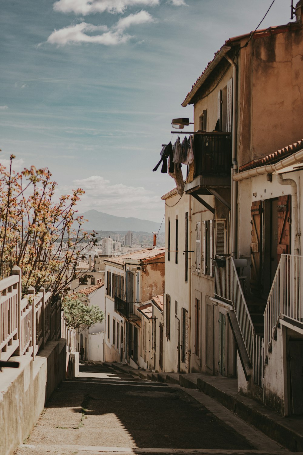 a narrow street with clothes hanging out to dry