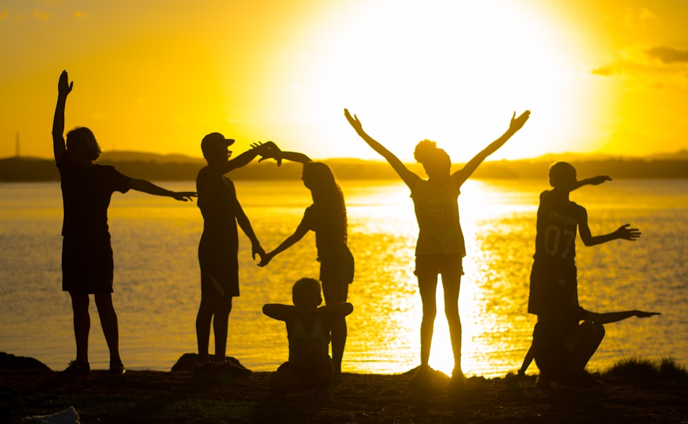 a group of people standing next to a body of water