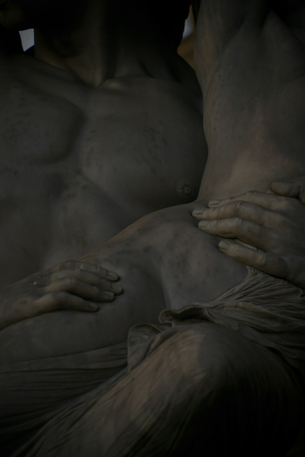 a close up of a statue of a man with his hands on his chest