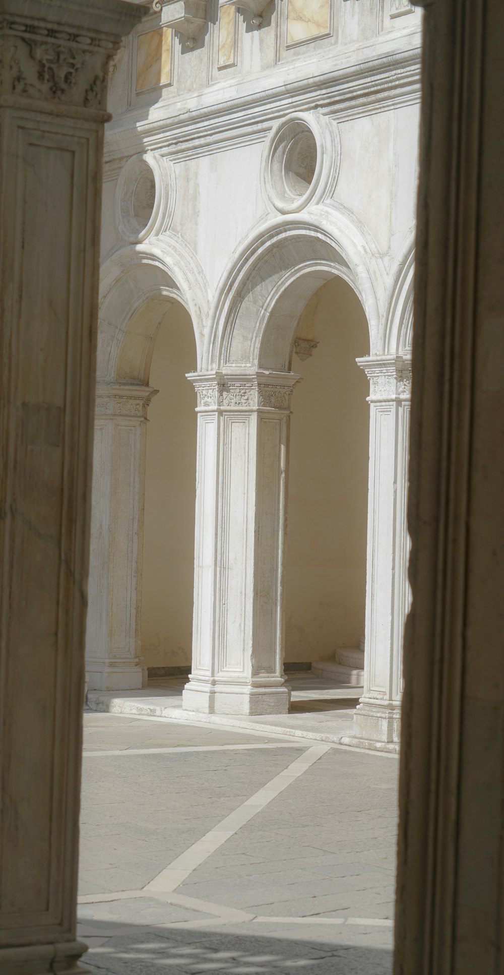 a white building with columns and a clock