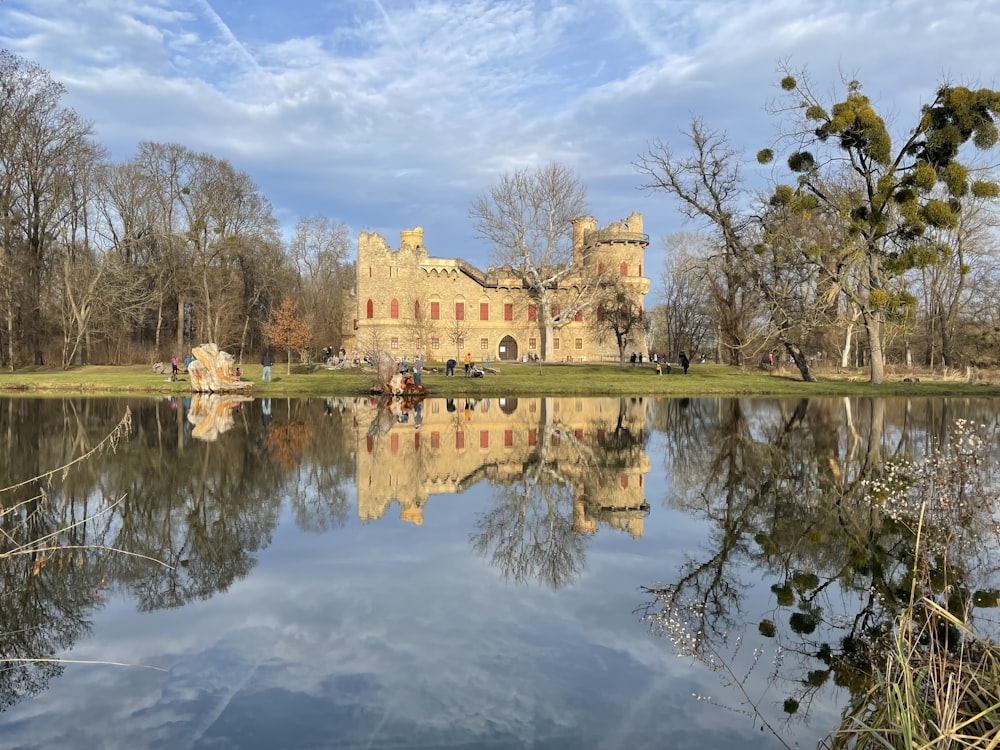 a large castle sitting on top of a lush green field