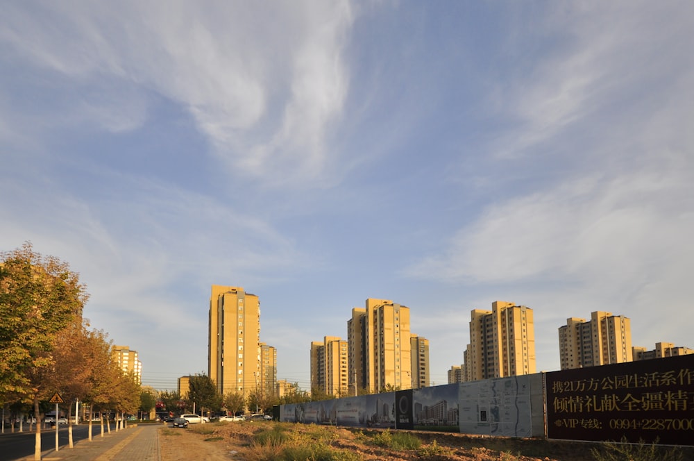 a dirt road with buildings in the background