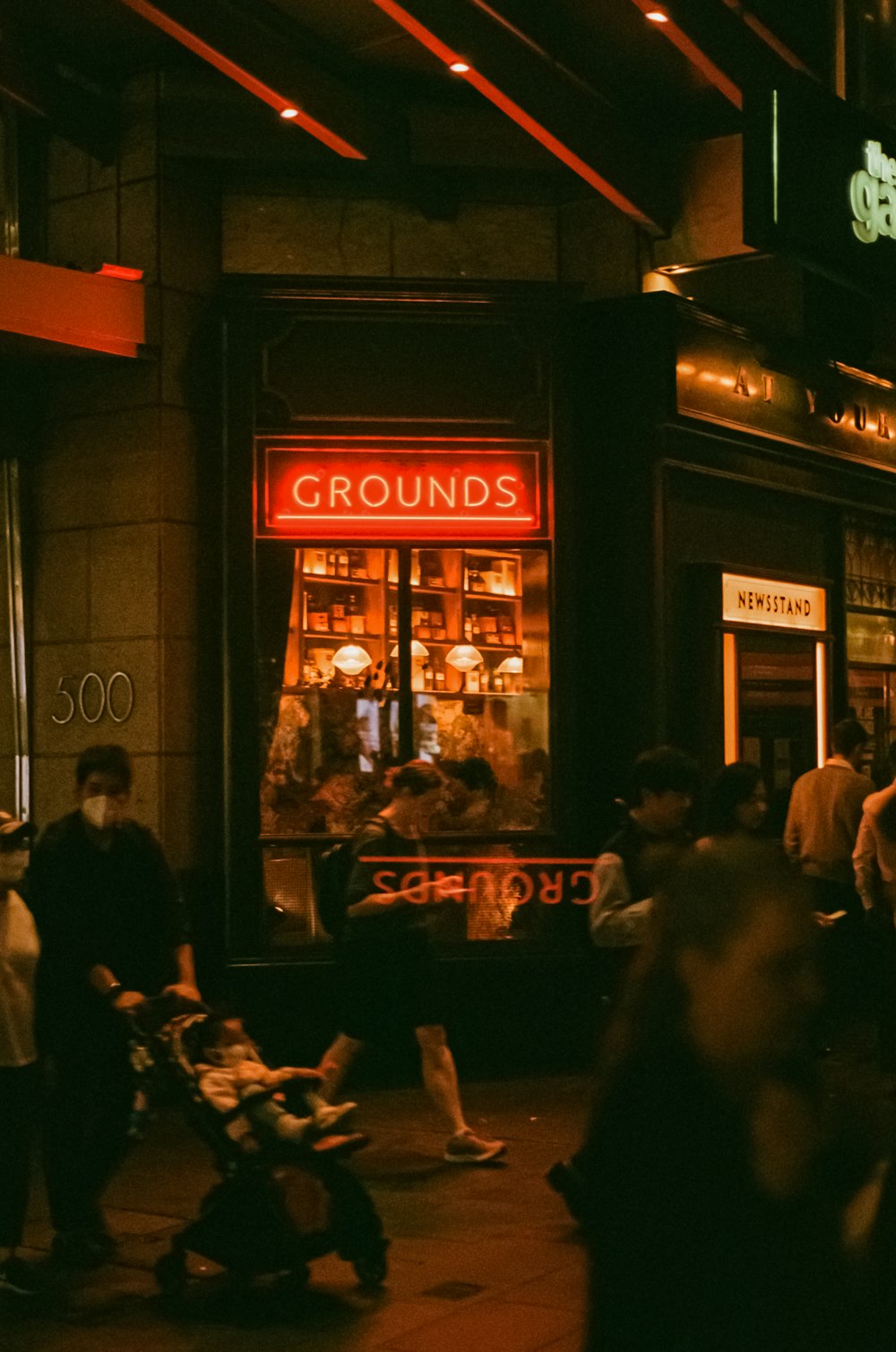 a group of people standing outside of a store