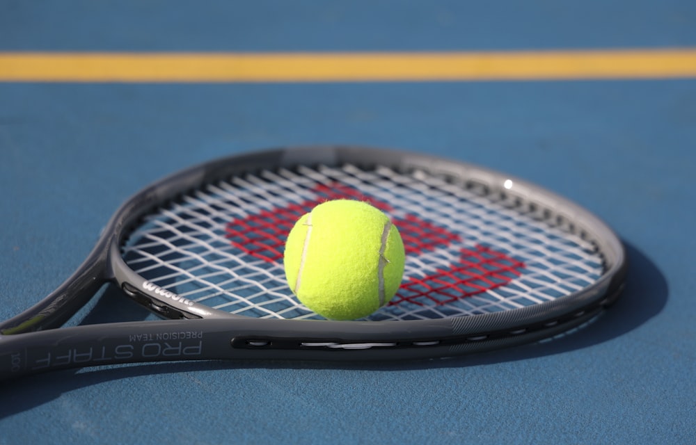 a tennis racket and a tennis ball on a tennis court