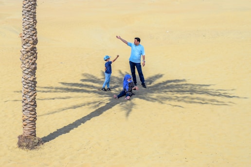 A happy Indian family enjoying a scenic Dubai desert safari at sunset.
