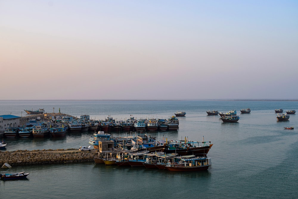 a group of boats floating on top of a body of water