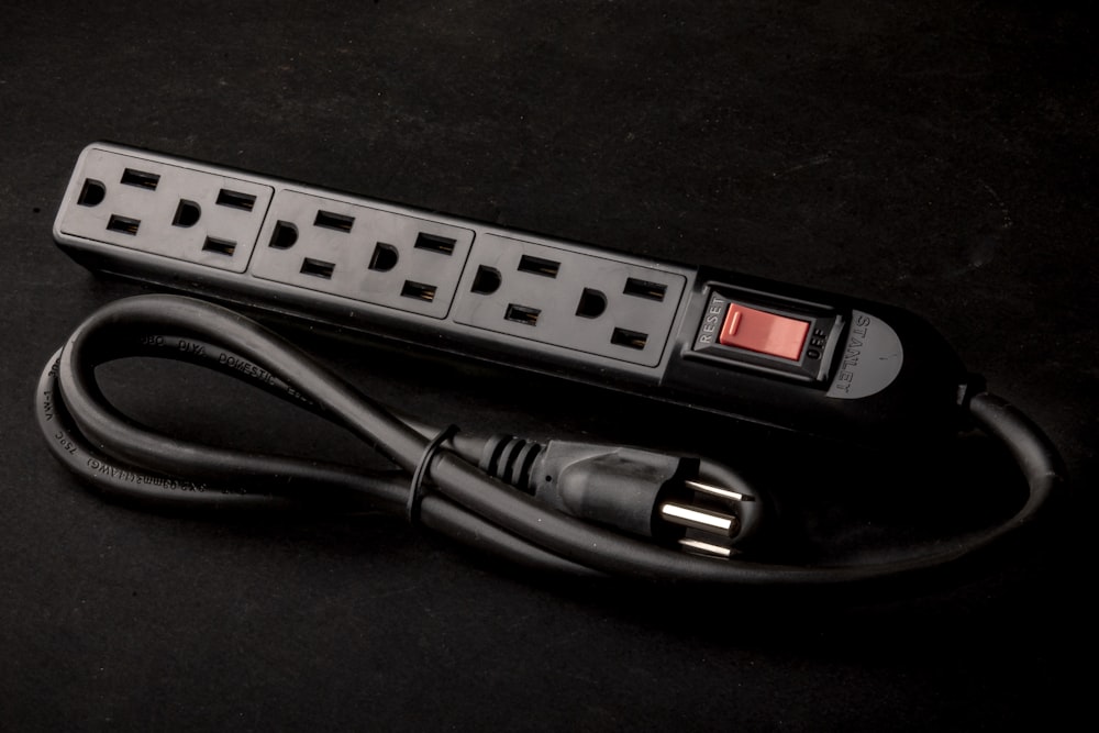 a black power strip sitting on top of a table