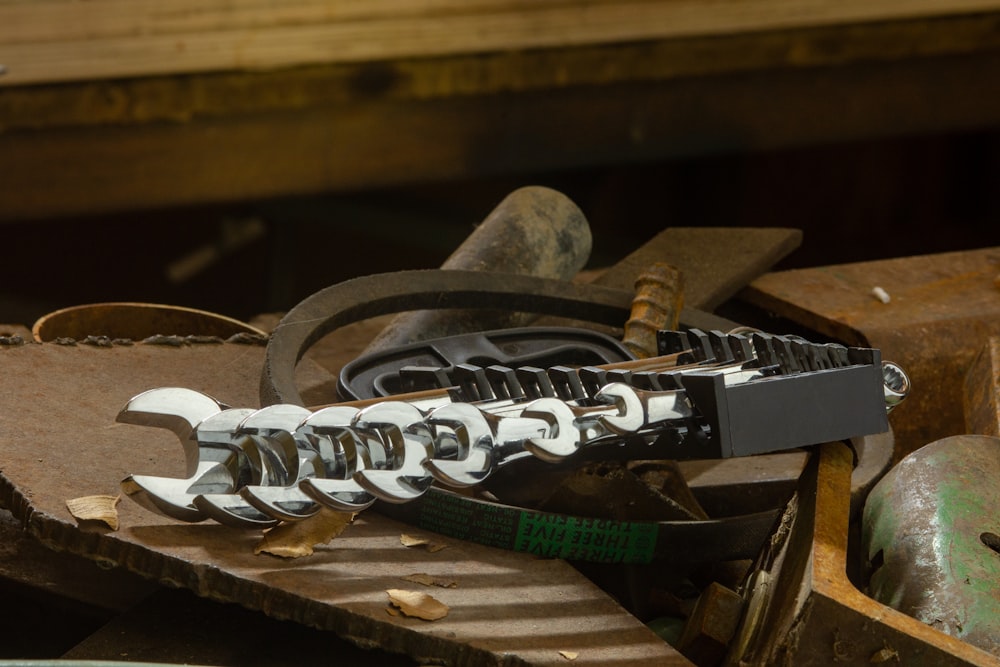 a couple of wrenches sitting on top of a piece of metal