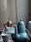 a blue teapot sitting on top of a table