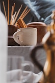 a close up of a table with a coffee pot and cups