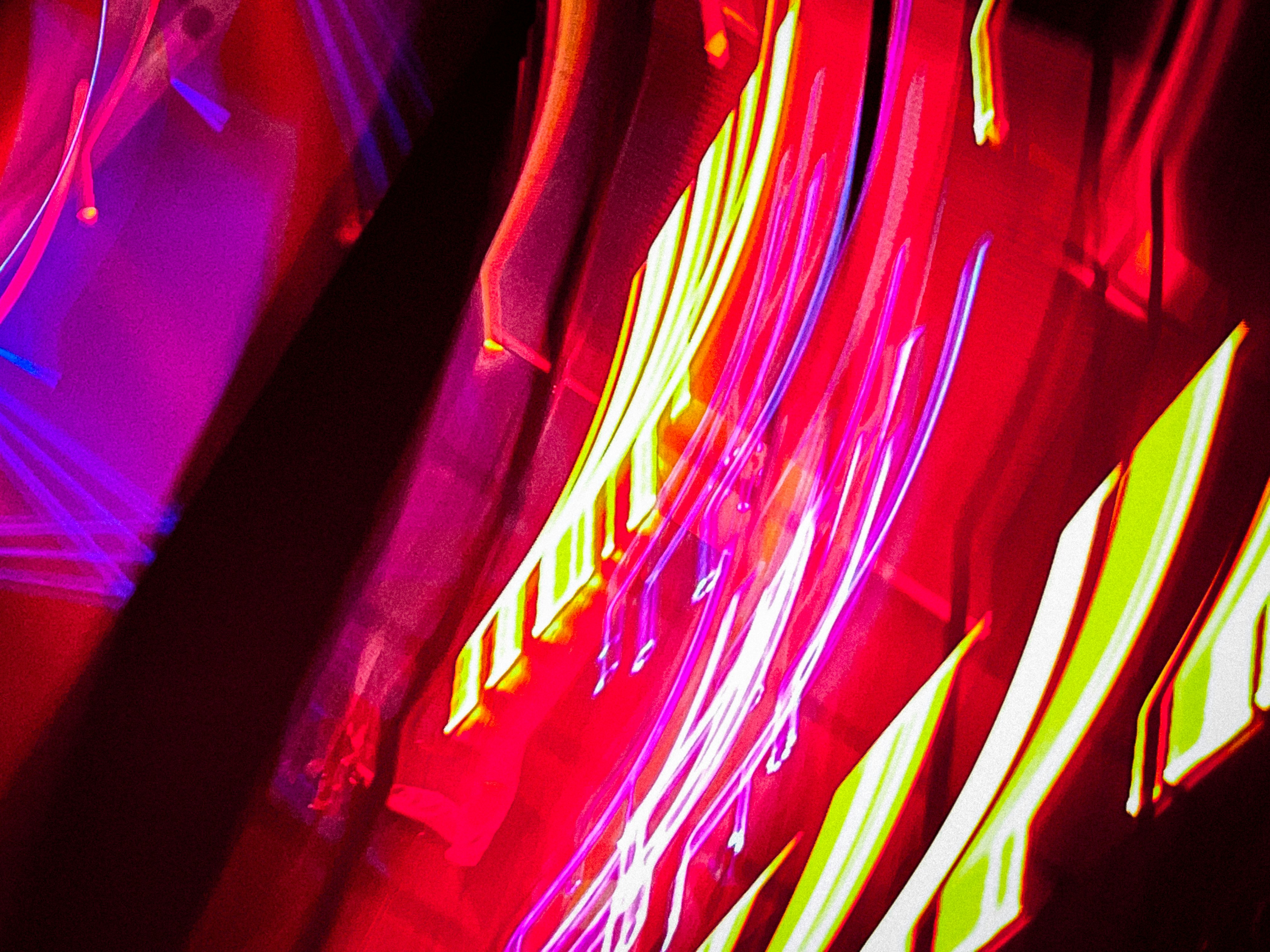 Abstract motion blur light trails in dark environment, electric blue and purple streaks, deep shadows