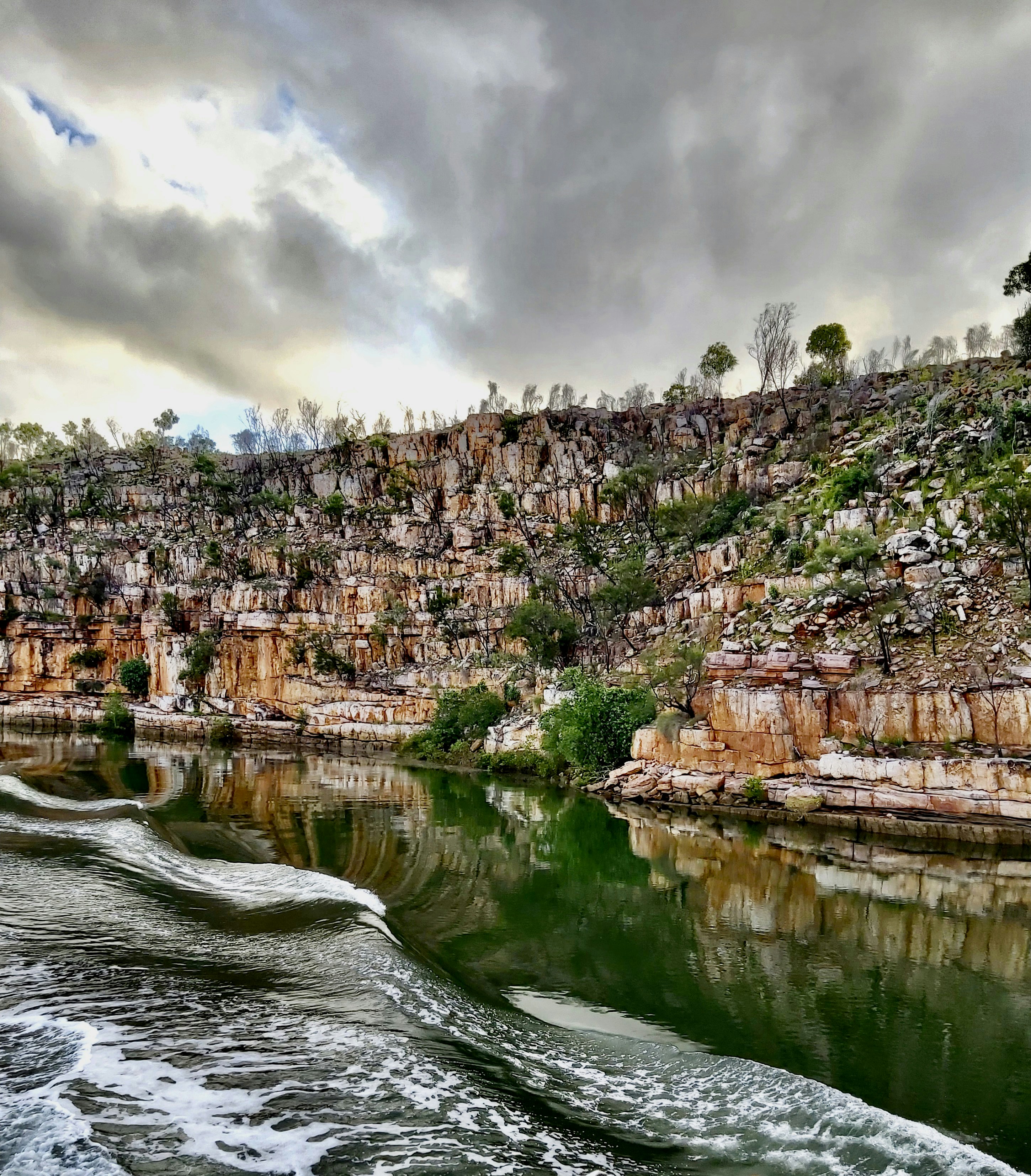 a body of water near a rocky cliff