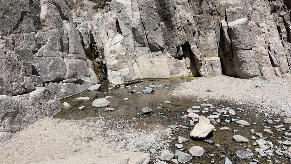 a small stream running between two large rocks