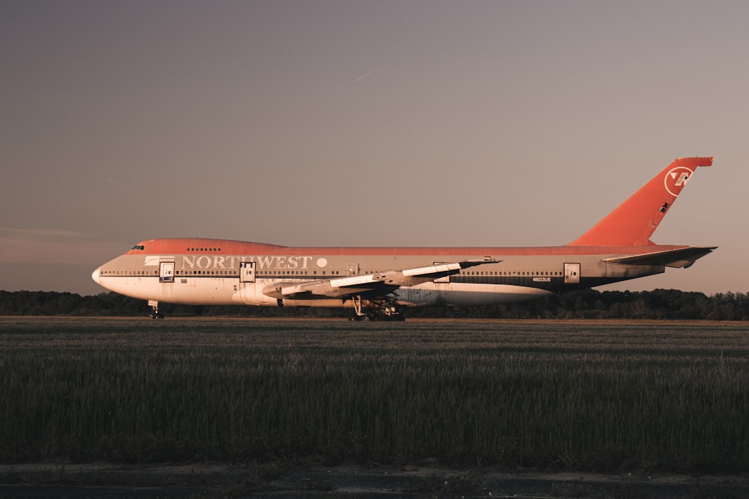 an orange and white airplane is on the runway