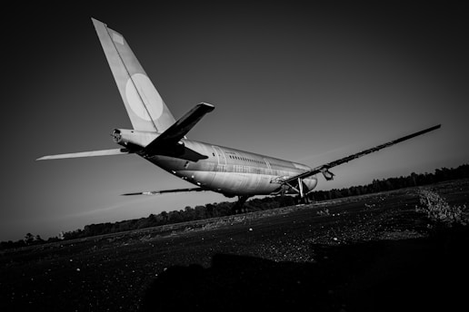 a large airplane sitting on top of a grass covered field