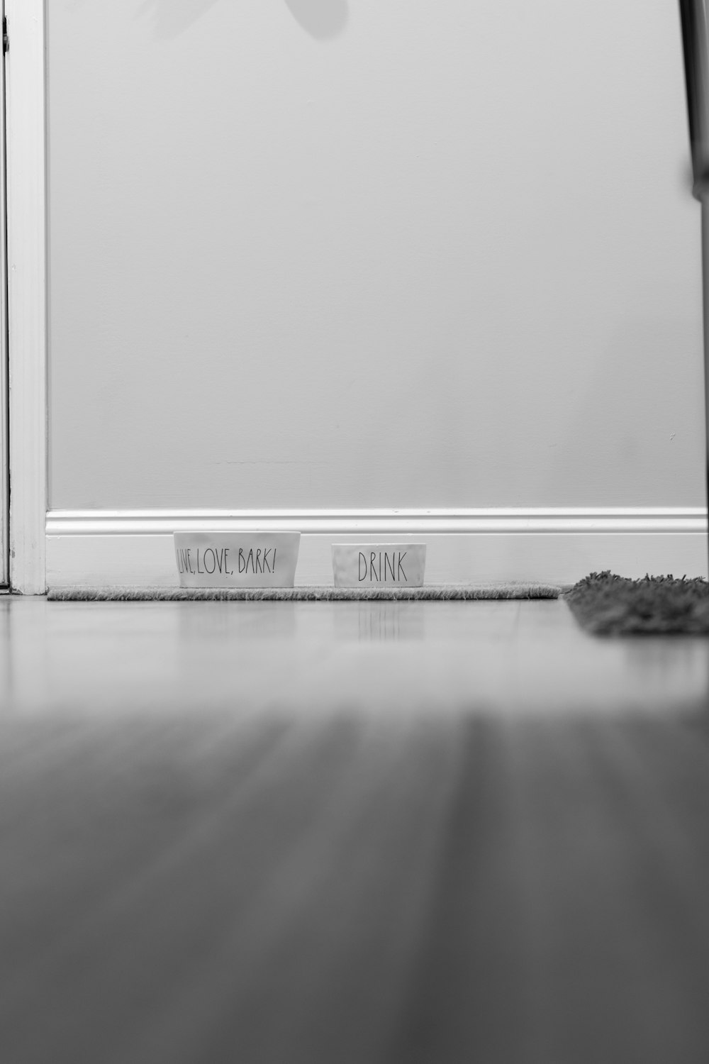 a black and white photo of a door and a sign